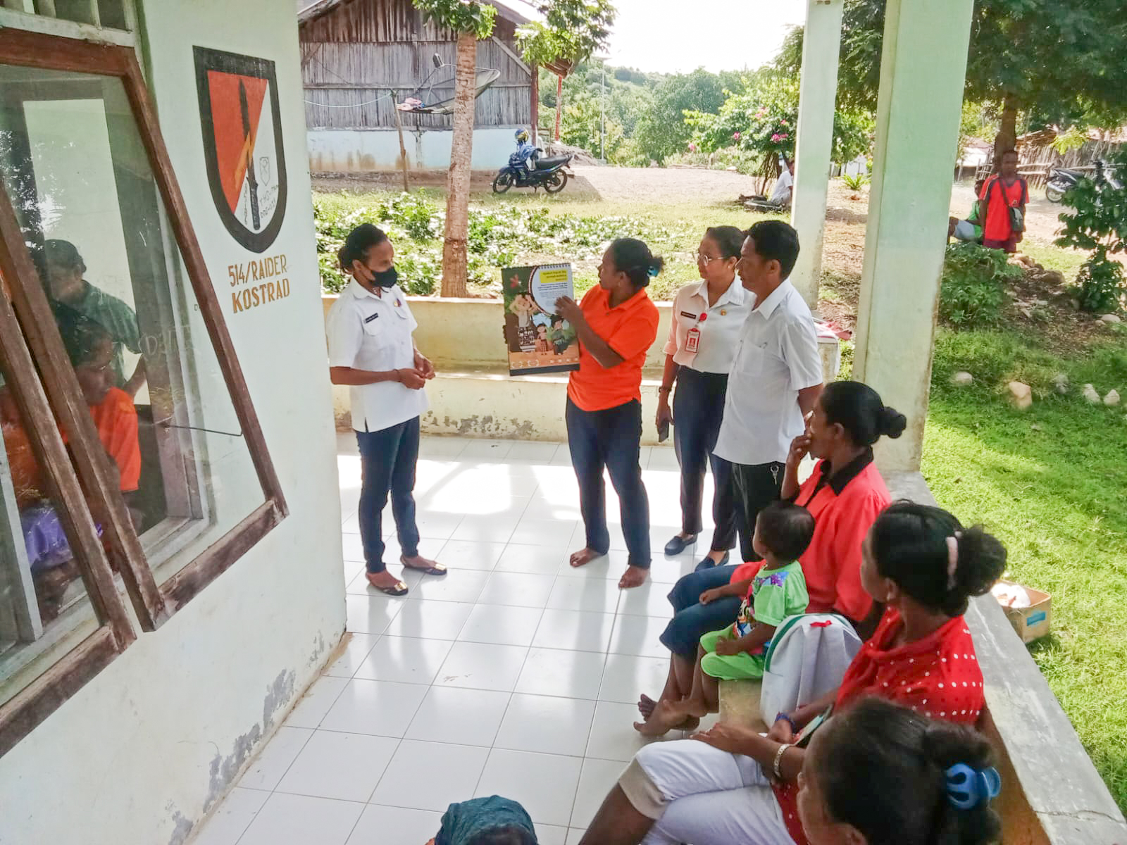 Community health worker providing malaria education using CIE materials